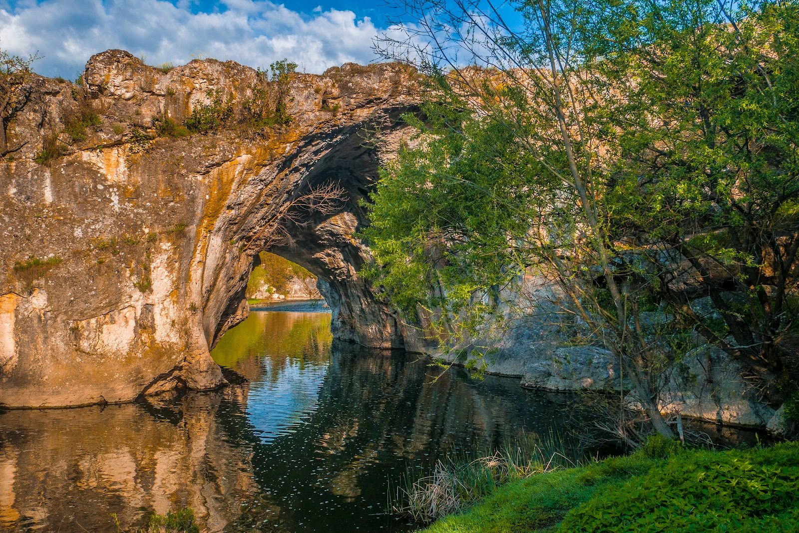 Natural stone arch on the river Vit